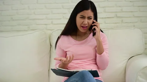 Asian woman holding smartphone with E-commerce Shopping online website Reading O Stockbeeldmateriaal 268779727