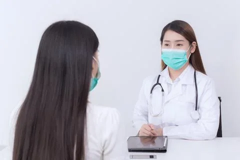 Asian woman patient consults her health with doctor, doctor give counsel. Stock Photos