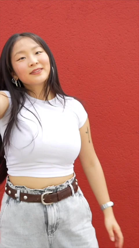 Asian woman pointing ahead while dancing K-pop Stock Footage 299810942