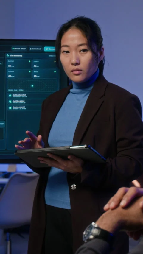 Asian Woman Presenting Cybersecurity Data on Screen in Office Stock Footage 347317841