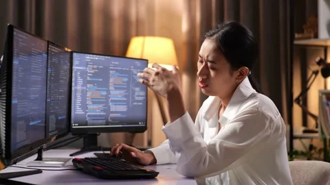 Asian Woman Programmer Having A Headache Creating Software Engineer Developing Video stock 232033755