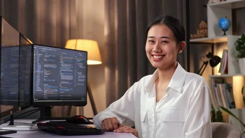 Asian Woman Programmer Smiling To Camera While Creating Software Engineer Video stock 232034182