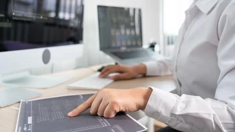 Asian Woman programmer typing source codes Programming On Computer in office, Stock Photos