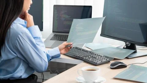 Asian woman programmer typing source code with computer pc for Developing pro Stockfoto's