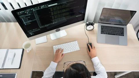 Asian Woman programmer typing source codes Programming On Computer in office, Foto stock