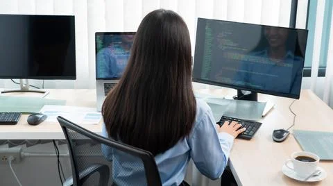 Asian woman programmer typing source code with computer pc for Developing pro Stock Photos