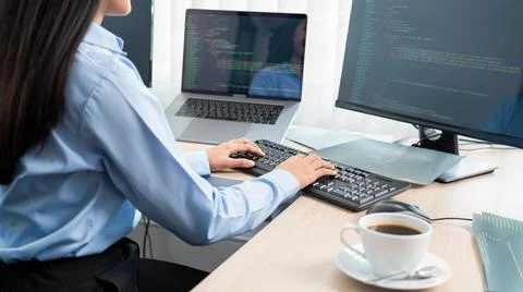 Asian woman programmer typing source code with computer pc for Developing pro Stockfoto's