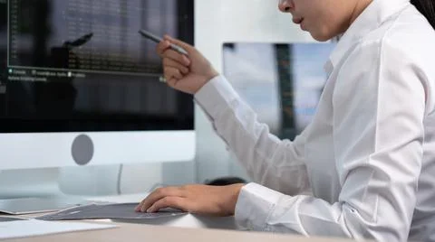 Asian Woman programmer typing source codes Programming On Computer in office, Foto stock