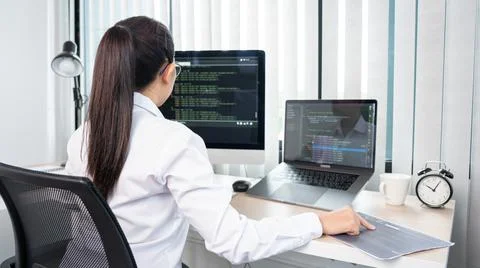 Asian Woman programmer typing source codes Programming On Computer in office, Stock Photos
