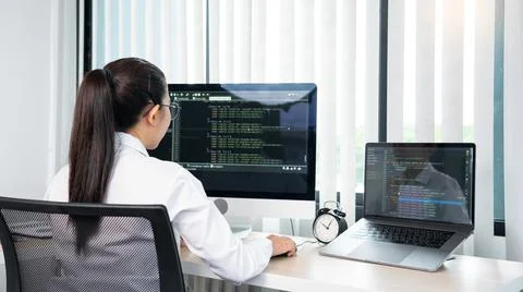 Asian Woman programmer typing source codes Programming On Computer in office, Stock Photos