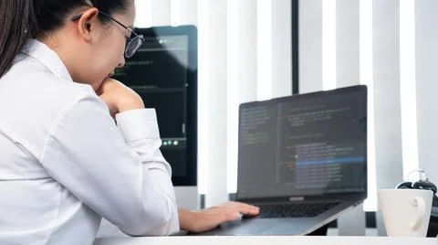 Asian Woman programmer typing source codes Programming On Computer in office, Stock Photos