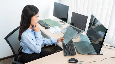 Asian woman Programming working with computer and typing data code to develop 库存照片