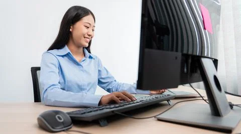 Asian woman Programming working with computer and typing data code to develop 写真素材