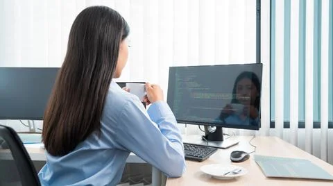 Asian woman Programming working with computer and typing data code to develop Stock Photos