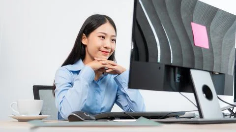 Asian woman Programming working with computer and typing data code to develop Fotos de archivo