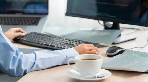 Asian woman Programming working with computer and typing data code to develop Foto stock