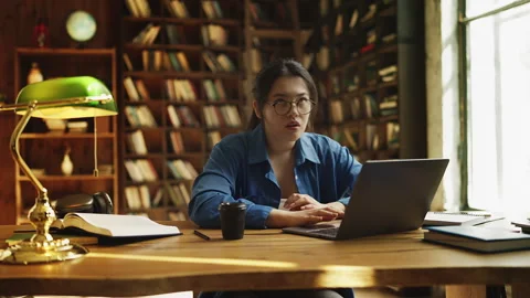 Asian woman reading program error message on laptop, frustrated by lost file 스톡 동영상 329788777