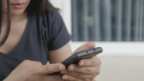 An Asian woman with serious expression while using phone. Stock Footage 156509421