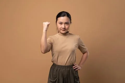 Asian woman showing a trust isolated on beige background. Stock Photos