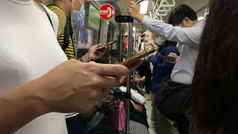 Asian woman stand up in the train. Using smartphone in subway. Phone device Stock Footage 164169832