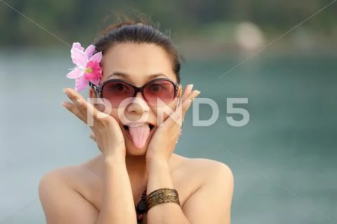 Asian woman sticking tongue Stock Photos