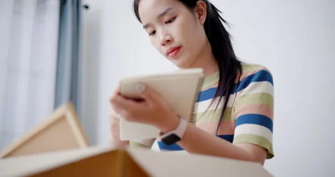 Asian woman is taking notes while checking belongings Stock-Footage 295023770