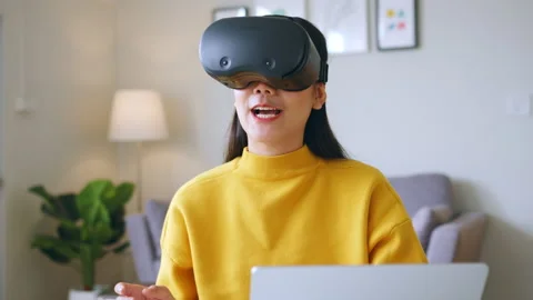 Asian woman talking while using 360 VR headset for online meeting in metaverse Stock Footage 190005894