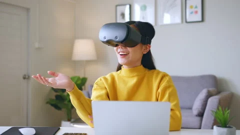 Asian woman talking while using 360 VR headset for online meeting in metaverse Stock Footage 190171384