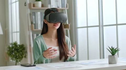 Asian woman talking while using 360 VR headset for online meeting, metaverse Stock Footage 196901191
