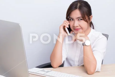 Asian woman telling secret in the office Stock Photos