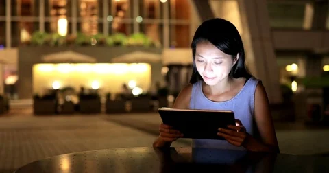 Asian woman use of tablet computer at night Stock Footage 79846504