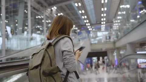 Asian woman using and checking her smartphone in airport. Stock Footage 105279141