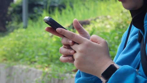 Asian woman using and texting on her smartphone Stock Footage 337089657