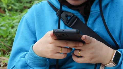 Asian woman using and texting on her smartphone Stock Footage 337089692