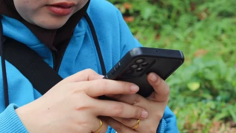 Asian woman using and texting on her smartphone Stock Footage 337089774