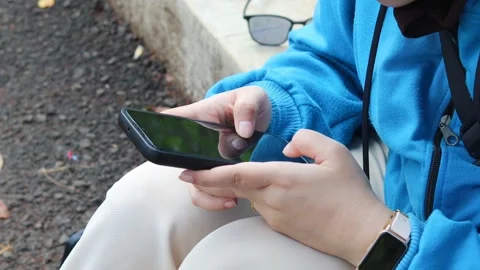 Asian woman using and texting on her smartphone Stock Footage 337089778