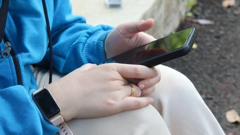 Asian woman using and texting on her smartphone Stock Footage 337089785
