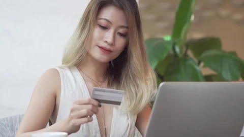 Asian woman using computer for online purchase with credit card Stock Footage 79258286