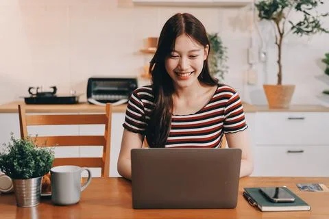 Asian woman using computer remote for business studying, watching online vi.. Fotos Stock
