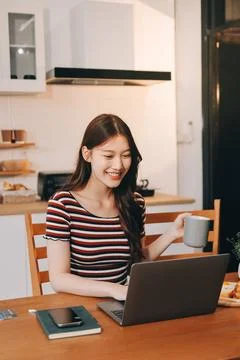 Asian woman using computer remote for business studying, watching online vi.. Fotos Stock