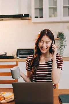 Asian woman using computer remote for business studying, watching online vi.. Fotos Stock