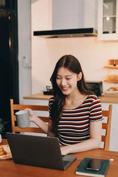 Asian woman using computer remote for business studying, watching online vi.. Fotos Stock