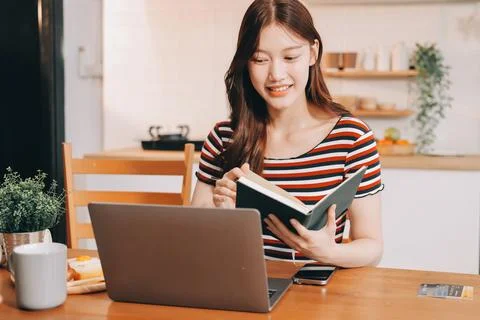 Asian woman using computer remote for business studying, watching online vi.. Фото