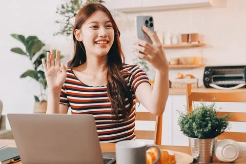 Asian woman using computer remote for business studying, watching online vi.. Fotos Stock