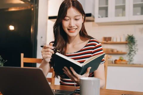 Asian woman using computer remote for business studying, watching online vi.. Fotos Stock