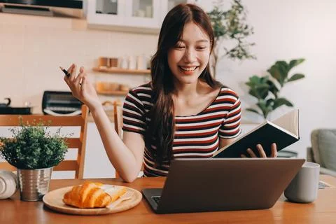 Asian woman using computer remote for business studying, watching online vi.. Fotos Stock