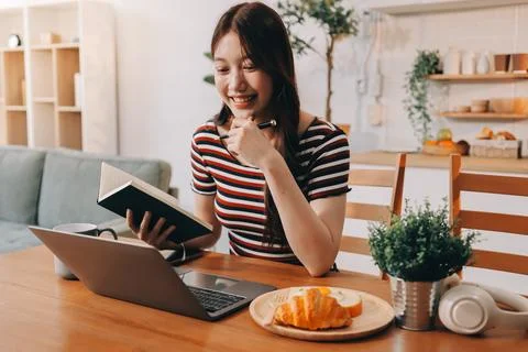 Asian woman using computer remote for business studying, watching online vi.. Fotos Stock