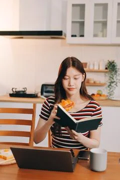 Asian woman using computer remote for business studying, watching online vi.. Fotos Stock