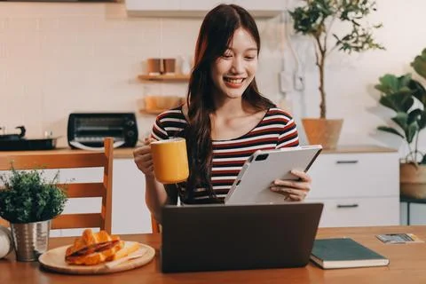 Asian woman using computer remote for business studying, watching online vi.. Fotos Stock