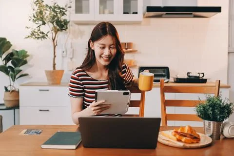 Asian woman using computer remote for business studying, watching online vi.. Fotos Stock